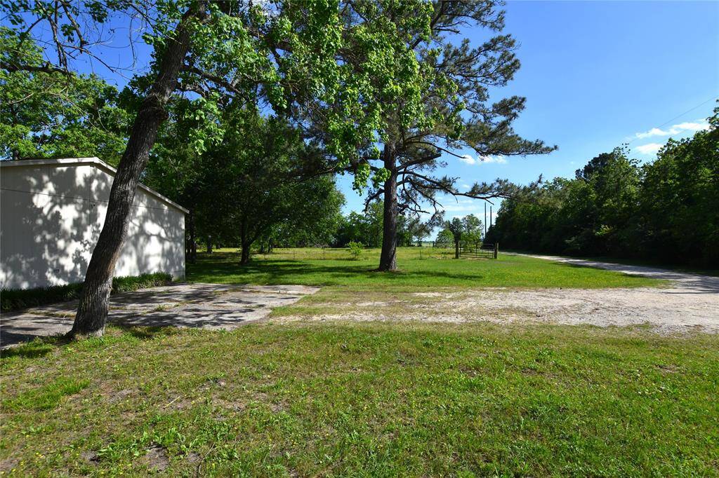 A well-maintained entry leads directly to a dedicated parking pad, providing a practical spot for guest parking, extra vehicles, or everyday use.