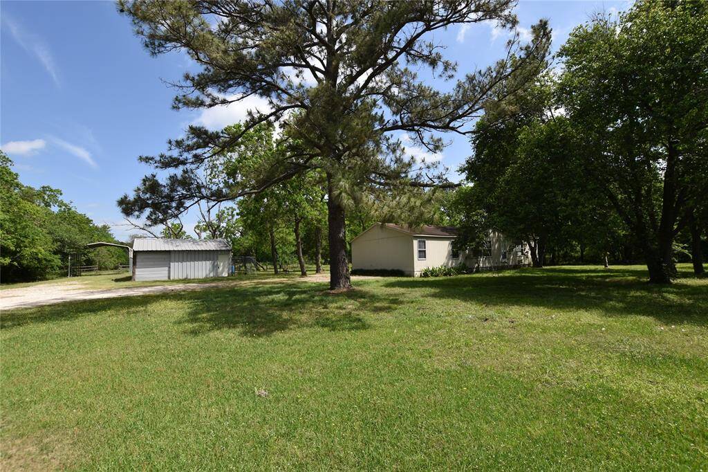 A dedicated road leads directly to a spacious covered RV parking area, offering ease of access and added convenience for guests or multiple recreational vehicles.