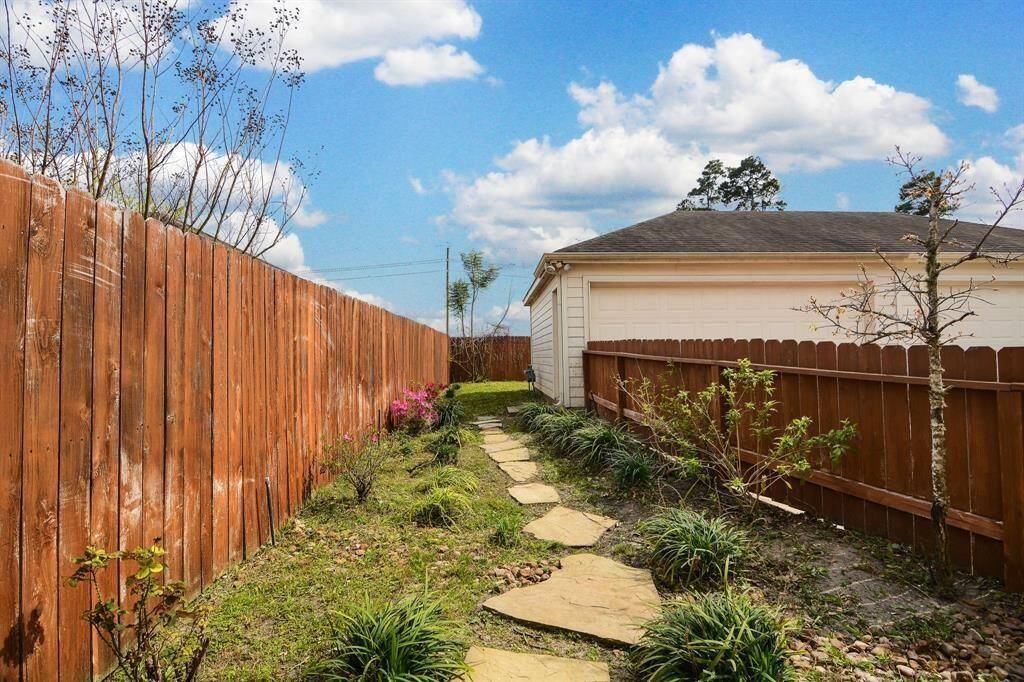 Small yard and pathway to garage.