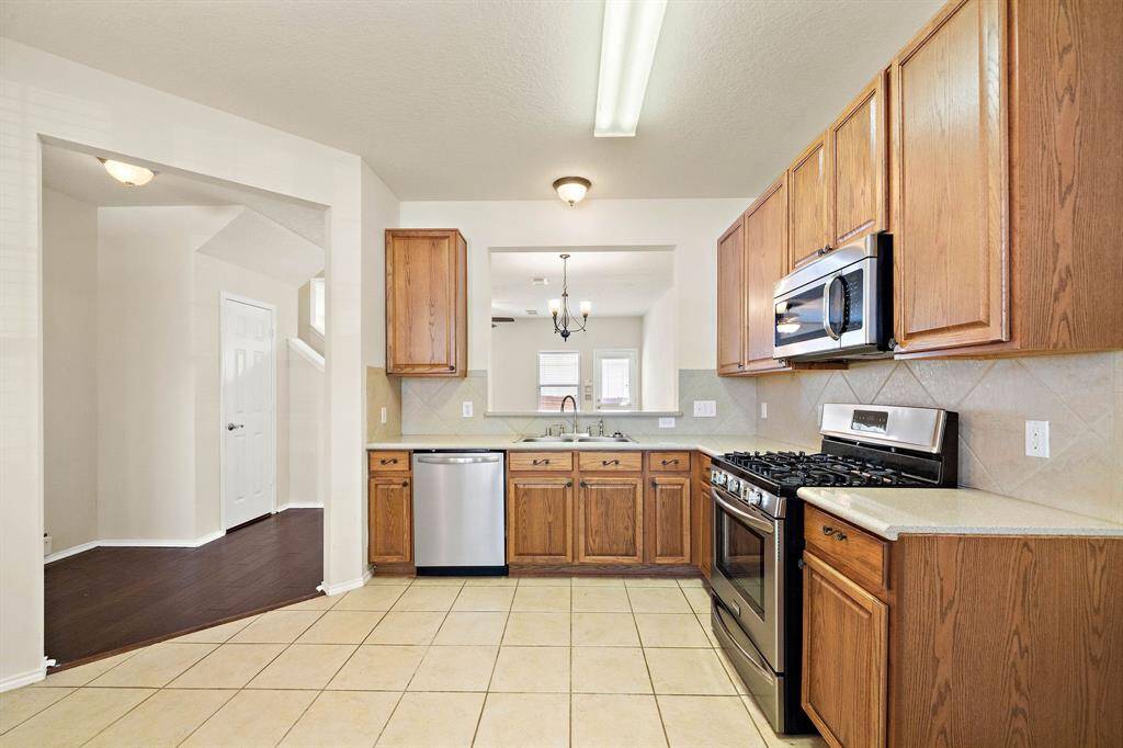 Large open kitchen with stainless steel appliances.