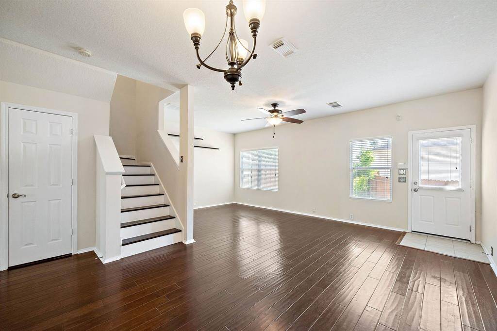 Beautiful laminate wood flooring in living and dining room combo.