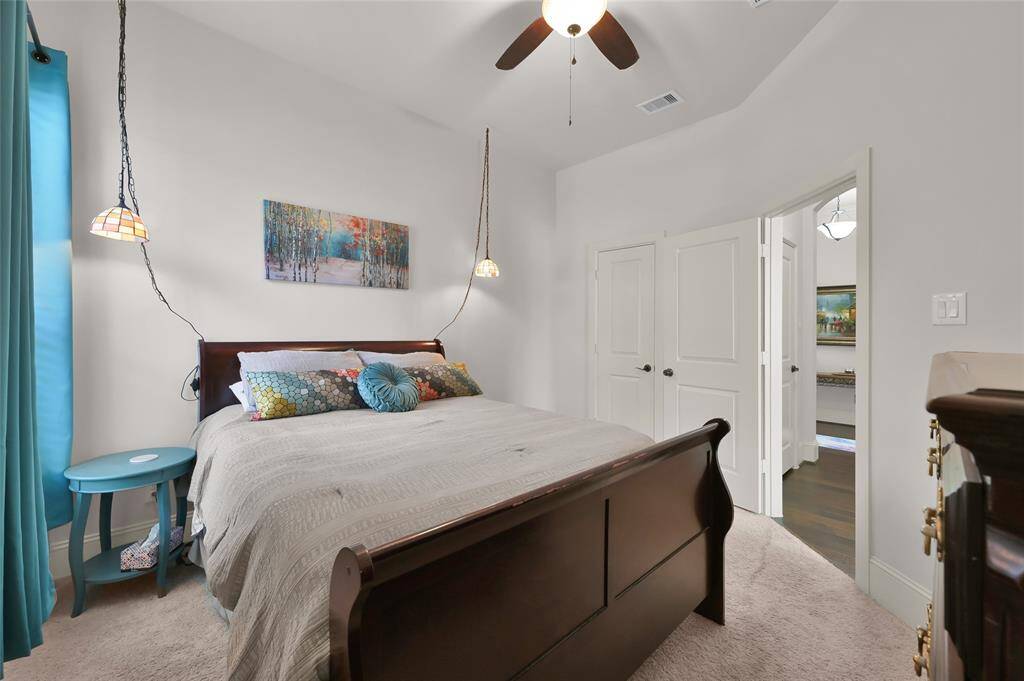 This cozy secondary bedroom has a bright window with carpet creating a welcoming atmosphere.