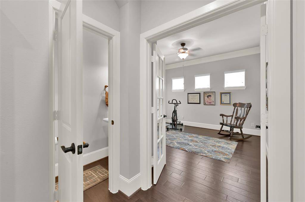The office space is accessible through double doors with an adjacent powder bathroom.