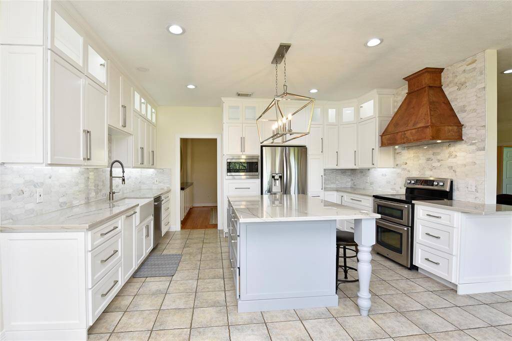 The family room also boasts solid oak floors, a wood burning fireplace, can lighting, built ins around the fireplace, floor plugs to make decorating easier and wonderful natural light along the back wall.