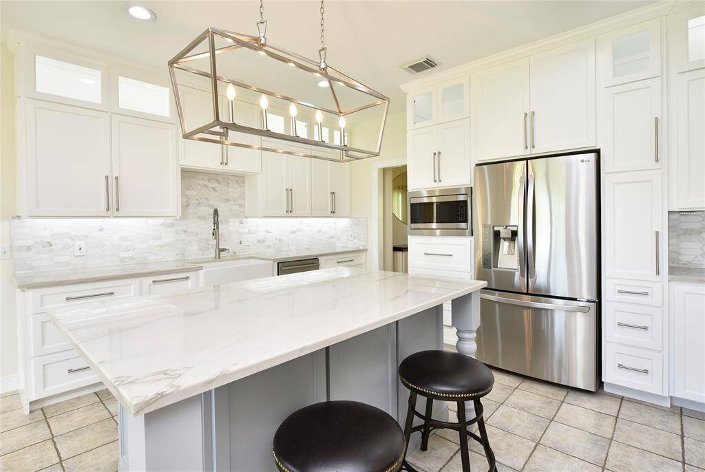 The quartzite counters are lovely. The owners are leaving the fridge for the buyers.