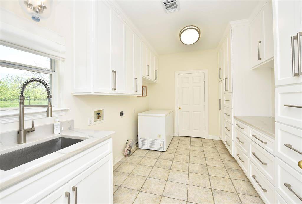 This kitchen was well thought out. This photo shows just 2 of the hidden features. The trash drawer keeps those trash cans hidden. The appliance cabinet makes storing and using those heavy mixers easy.