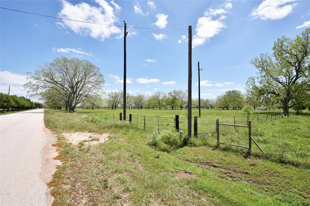 This photo is facing East and shows the homes down the road that borders the private road on the West side of this property.