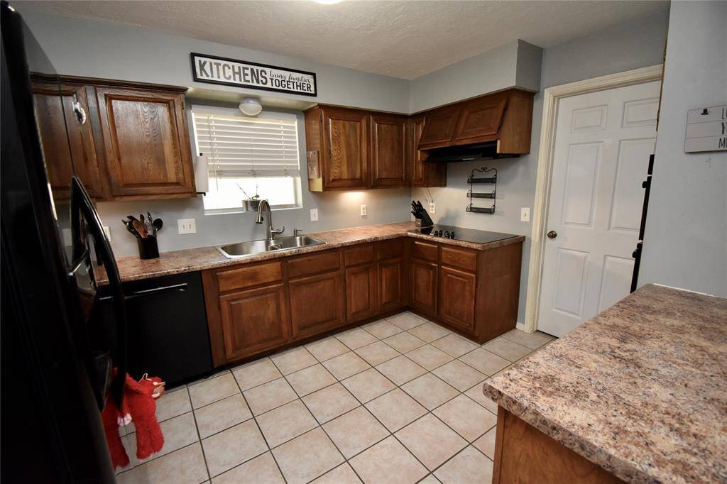 This kitchen features plenty of countertops and cabinetry.