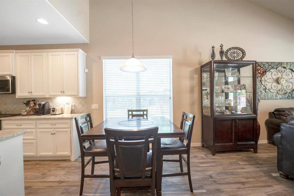 The dining room serves as a stylish bridge between the kitchen and family room, open to both for easy entertaining and effortless flow. Whether hosting a crowd or enjoying a quiet meal, this layout is perfect for both.