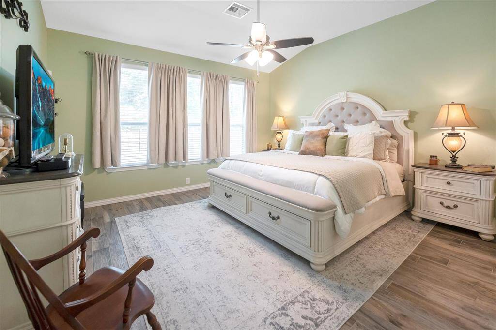 This posh owner’s retreat is the perfect place to unwind, with serene views of the patio, pool, and spa just beyond the windows. The spacious layout includes a walk-in closet and a spa-like ensuite bath, creating a private haven designed for rest and relaxation.