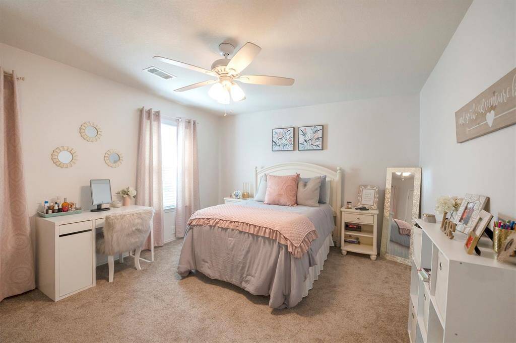 Your family and guests will enjoy sweet dreams in this spacious bedroom with soft neutral carpet and paint, a lit fan, large closet and easy access to a full bathroom.