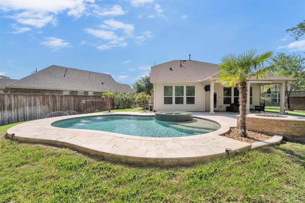 The backyard pool and raised spa are designed for both relaxation and fun, offering the perfect spot to enjoy long, hot summer days and sultry nights under the stars.