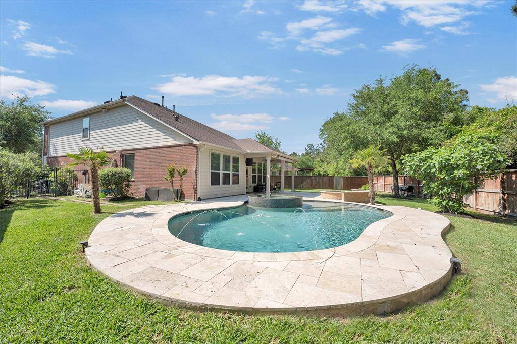 Even with the sparkling pool and expansive patio, there’s still plenty of grassy lawn for barefoot fun and play. The fully fenced yard with a sprinkler system offers privacy and peace of mind, perfect for laid-back afternoons outdoors.