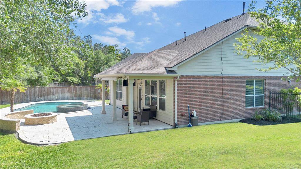 From the sparkling pool and raised spa to the cozy firepit and covered patio, this backyard is built for unforgettable moments. And with a spacious grassy lawn with a sprinkler system and a fully fenced yard, there’s still plenty of room for play, pets, and barefoot fun.