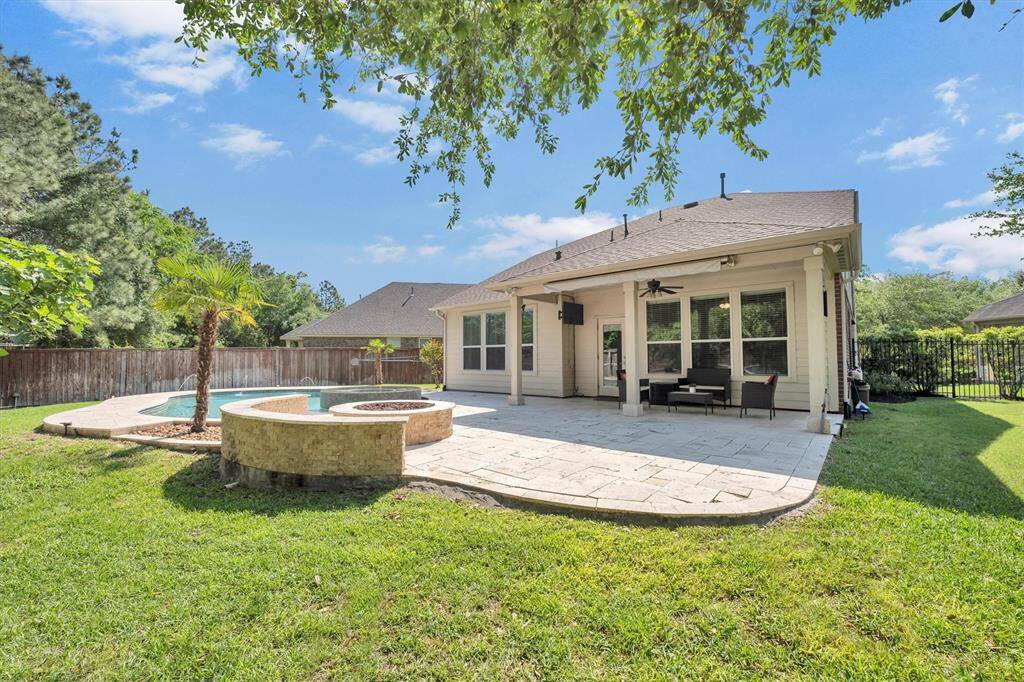 Gather around the firepit for cozy conversations or unwind on the covered patio with your favorite drink in hand. With plenty of seating and space to relax, this backyard is ready for evenings under the stars and effortless outdoor entertaining.