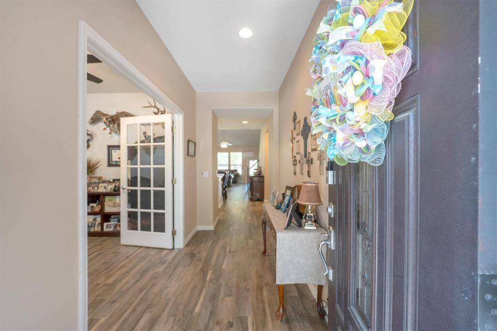 It'll be love at first sight! From the front door to the back, this home offers elegant finishes and amazing features including wood-look tile flooring, neutral paint, a romantic fireplace and soaring ceilings with chic lighting and fans. With plenty of space for both relaxed everyday living and effortless entertaining, this home checks every box.