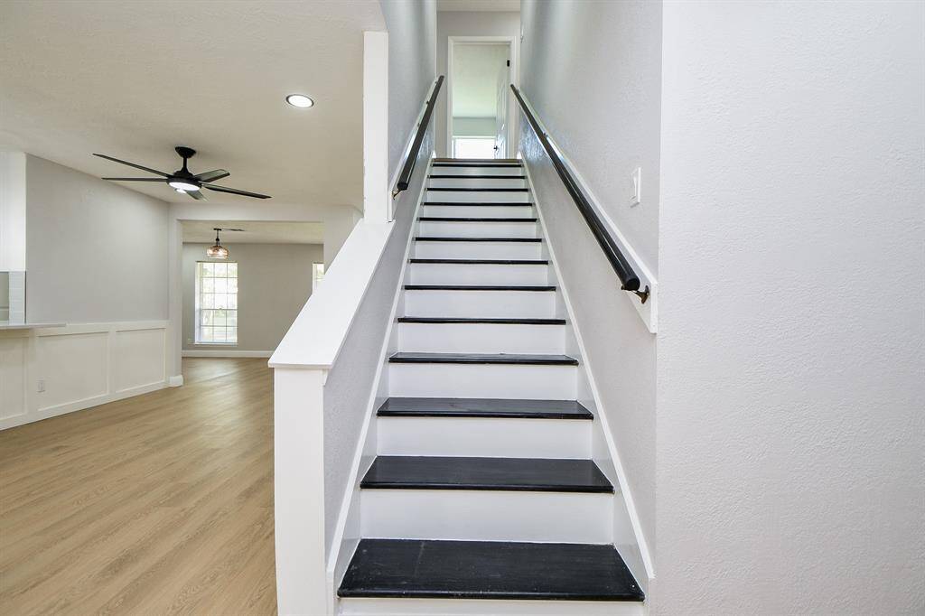 The inviting staircase leads to the upper floor with more bedrooms.