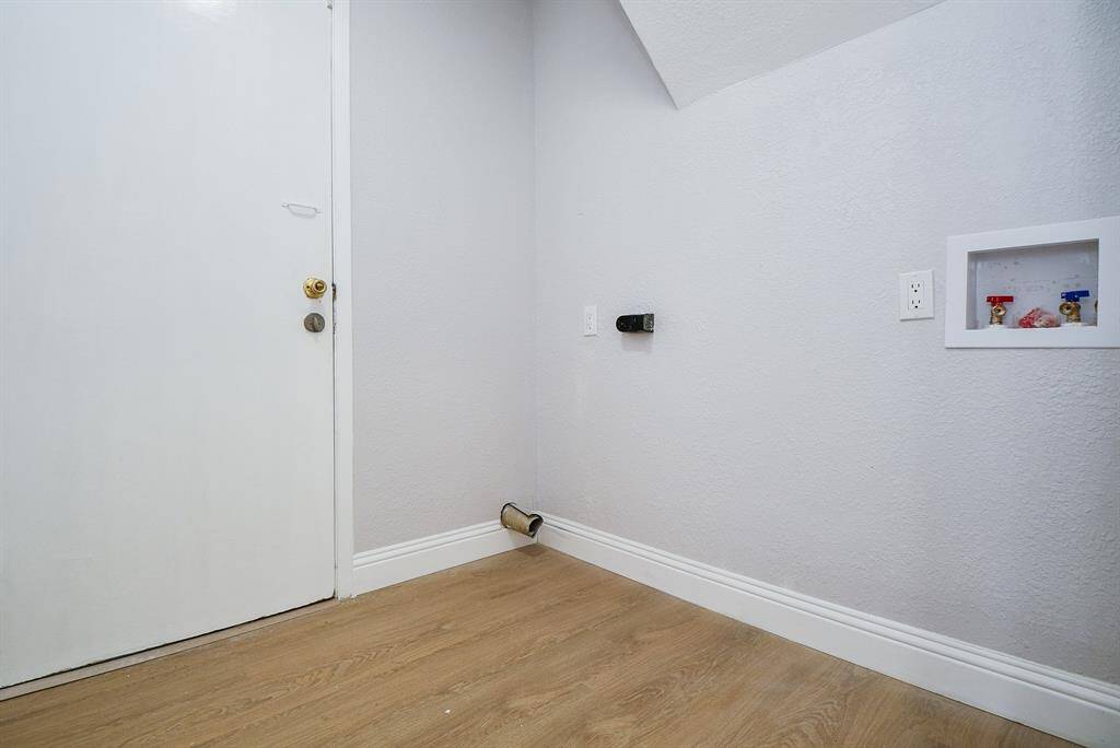 Your compact laundry area with hookups for a washer and dryer sitting between home and garage.