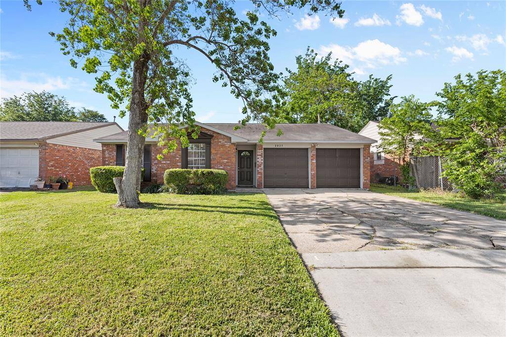 Charming single-story brick home with a well-maintained front yard, mature trees, and a wide driveway leading to a two-car garage. Ideal for buyers seeking a cozy, inviting atmosphere.