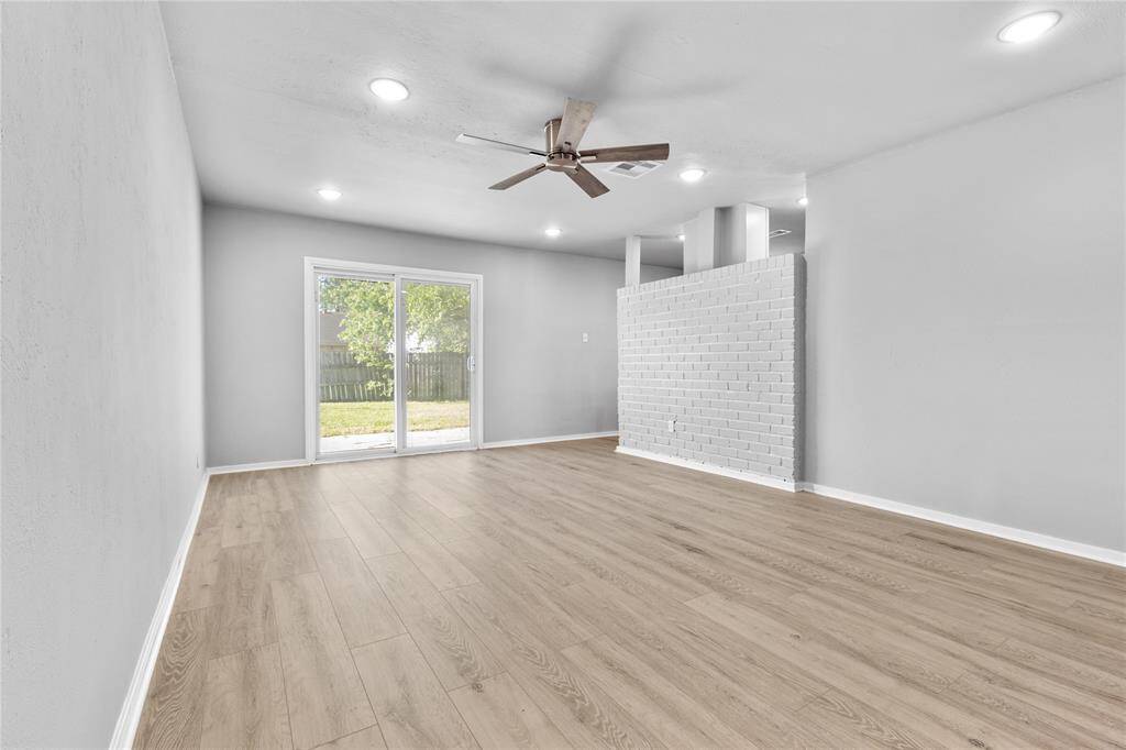 A sliding glass door leads to the backyard, and an accent wall adds character to the space.