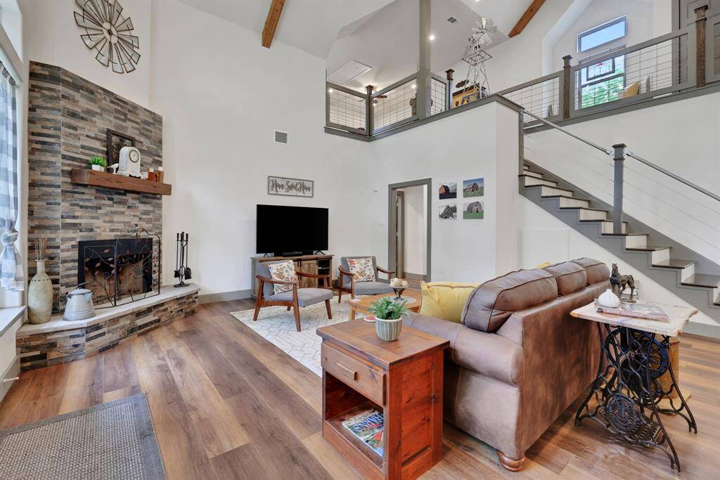 Perfect for entertaining or relaxing by the fire, this inviting space blends farmhouse character with contemporary comfort.