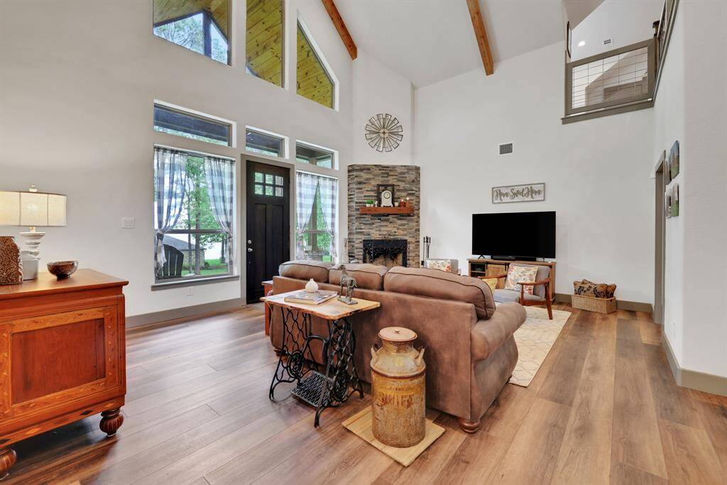 Natural light pours in through large windows, highlighting the stylish finishes and cozy ambiance.