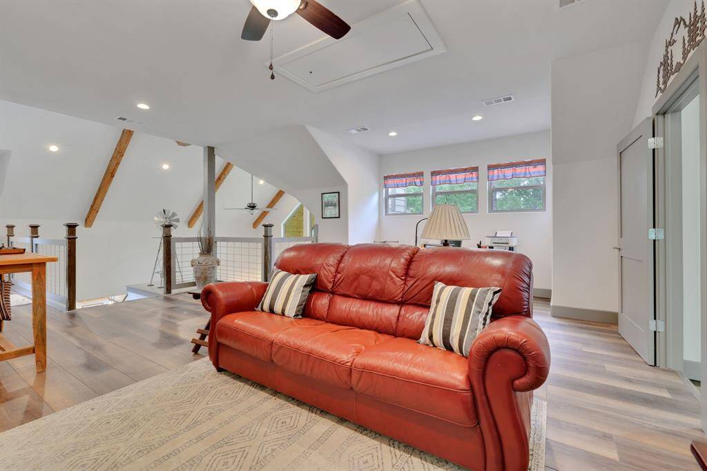 Overlooking the main living area, this loft offers a cozy retreat with natural light and a functional office nook, perfect for relaxation or productivity.