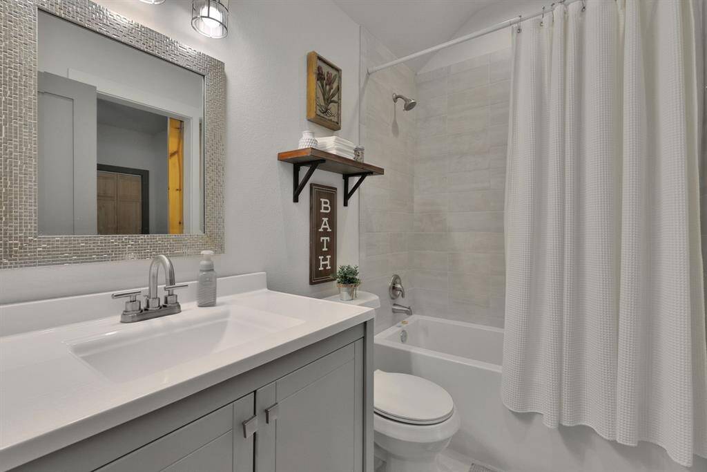 Guest bathroom features a tub/shower combo