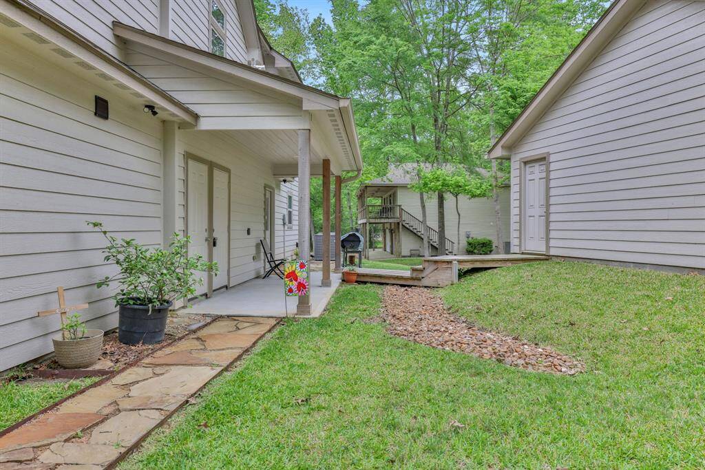 Out from the Utility room, there is a sidewalk leading up to the spacious 3 car garage
