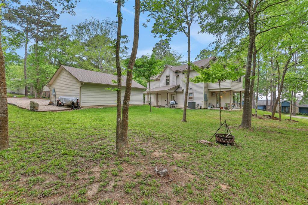 Backyard with detached garage/storage. Perfect for outdoor enjoyment.