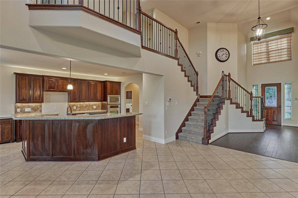 The eat-in kitchen is open to the family room and features a sizeable breakfast island for additional seating.