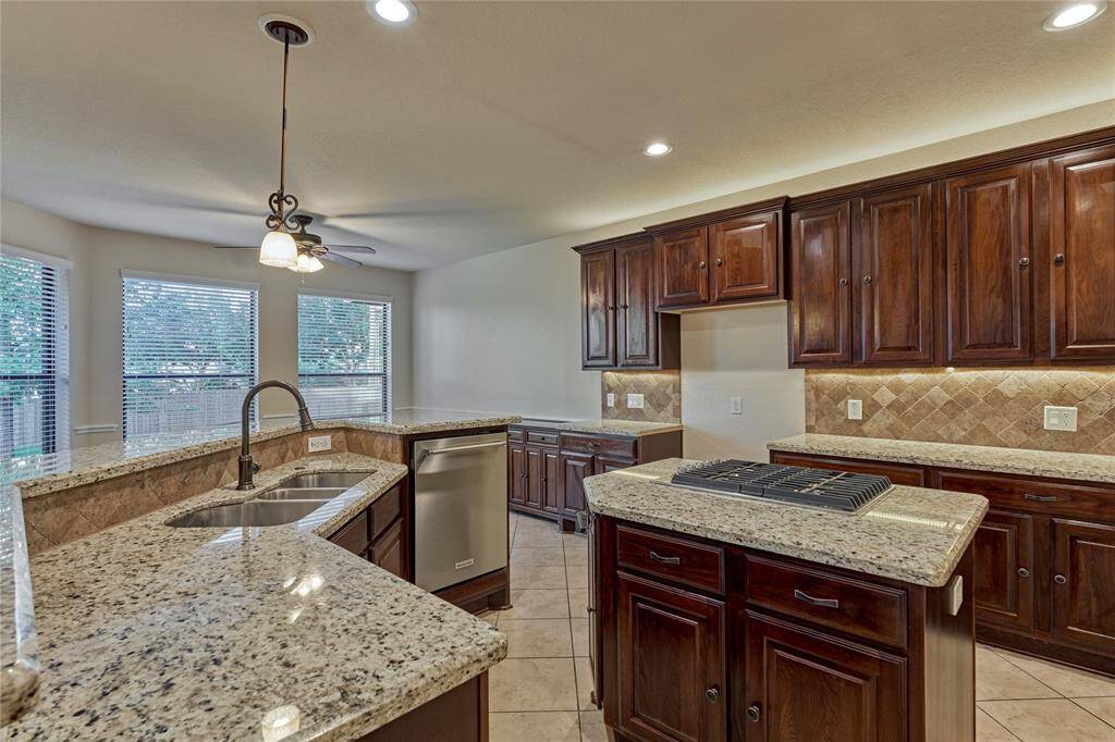 The center island features a gas cooktop and provides additional storage.