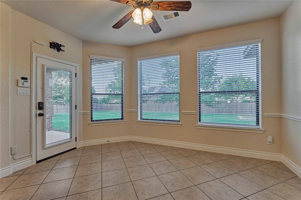 The sunny breakfast area to enjoy your morning coffee is spacious and offers peaceful views of the backyard.