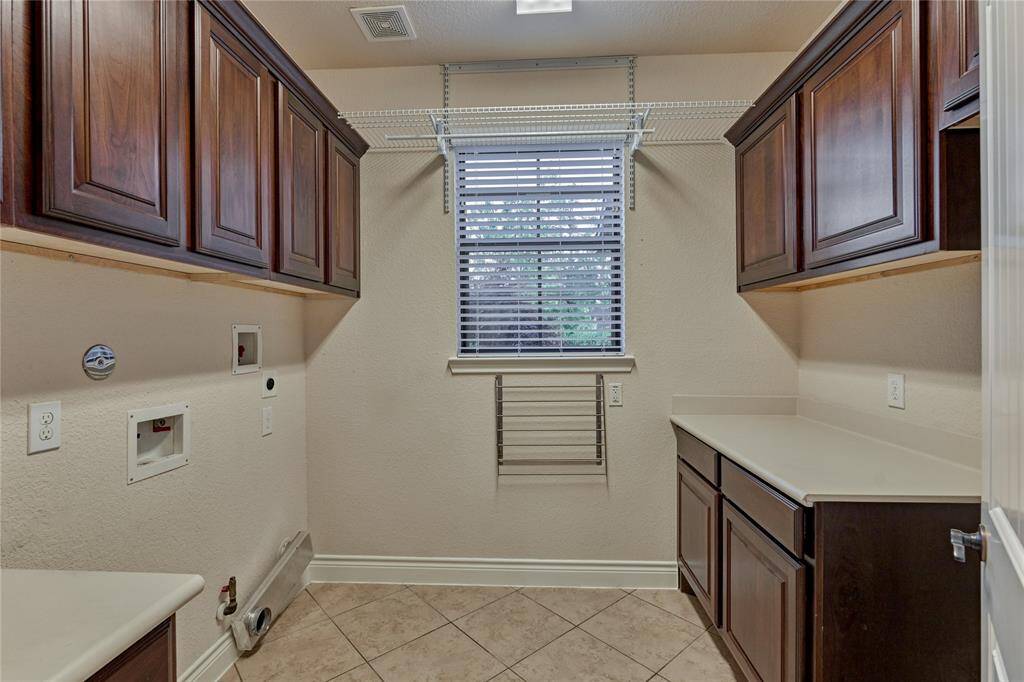 Ample storage and counterspace in the laundry room.