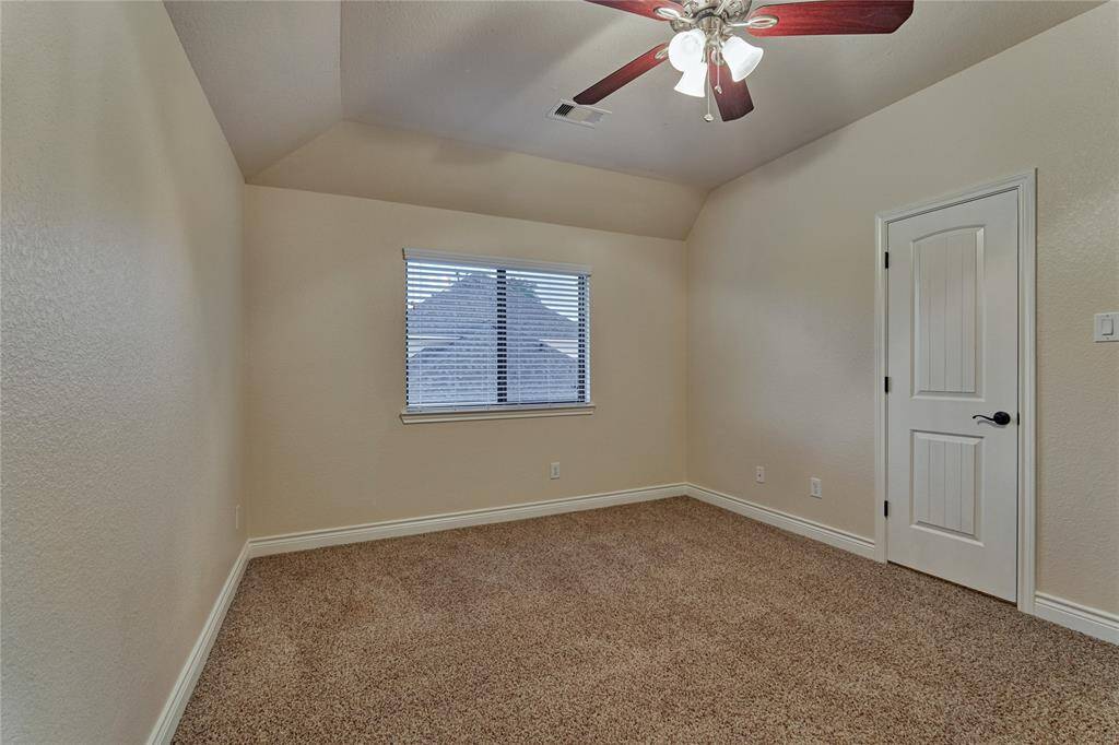 This bedroom has a side yard view.