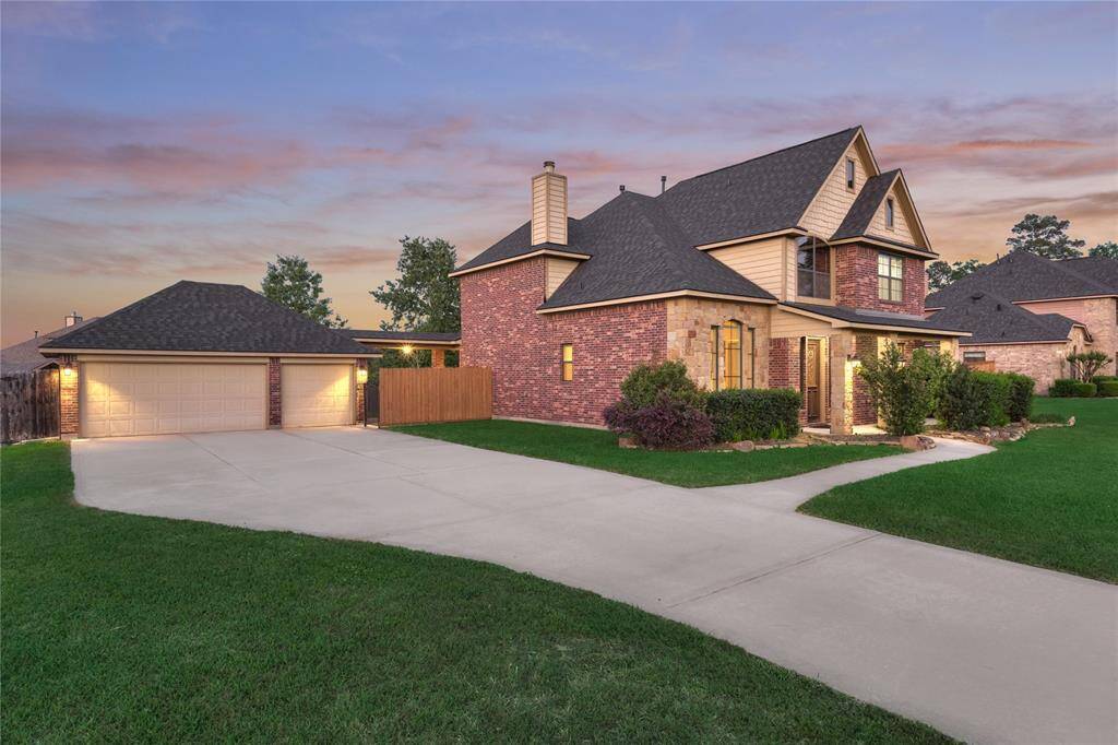 Spacious driveway leading to a generous 3-car garage with ample guest parking.