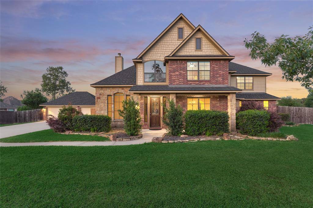 This stunning exterior blends brick, stone, and wood for an eye-catching and elegant facade.