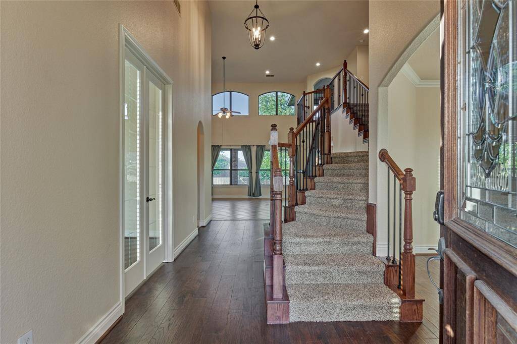 Welcome to a home with a grand staircase, soaring ceilings, and exquisite finishes.