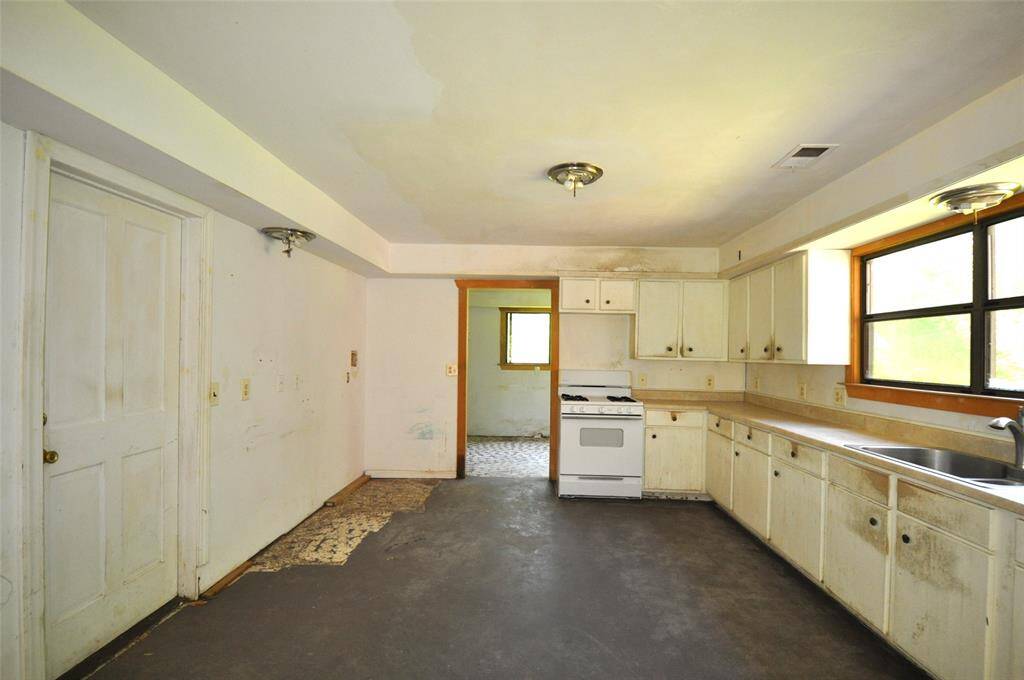 Kitchen area.  Laundry room all the way to the back.  Door on the left is to the garage.