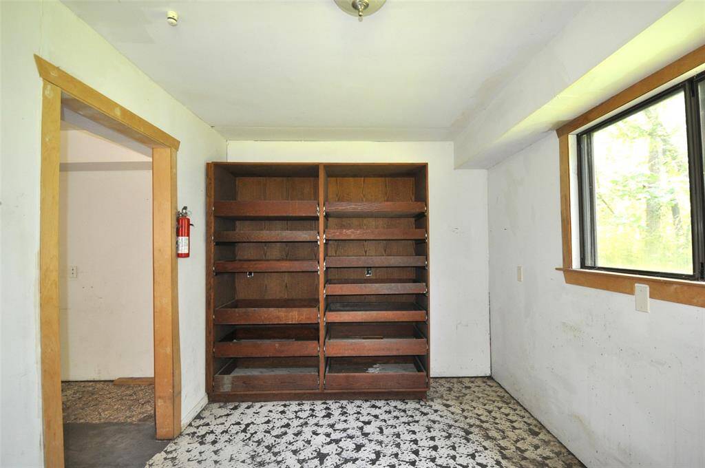 Laundry room has shelving to be used as a pantry.