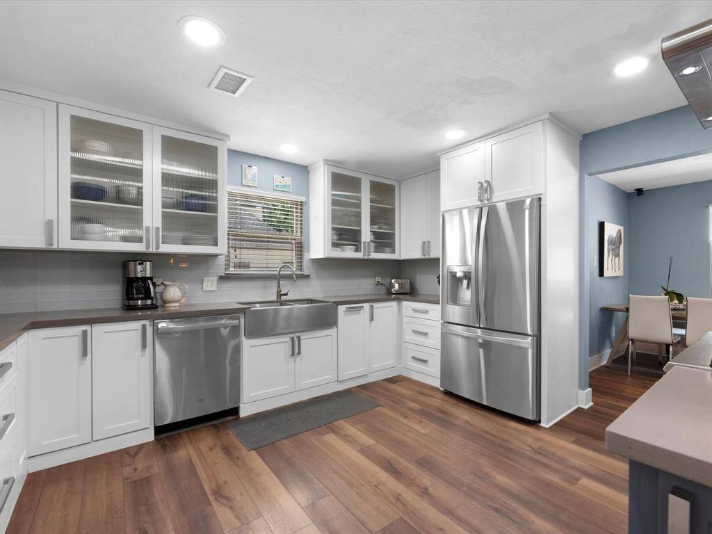 The floors carry through here with pretty white cabinets for contrast