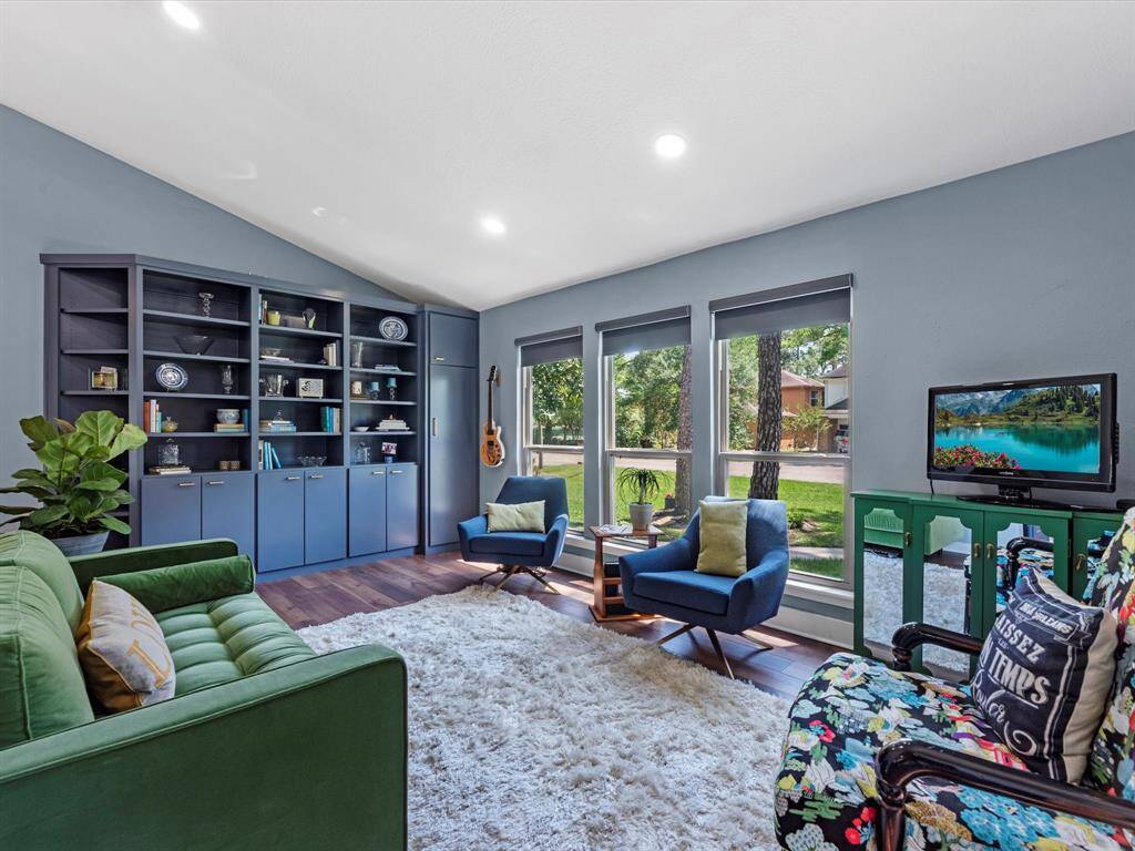 The front living room offers recent built ins for nice storage and display