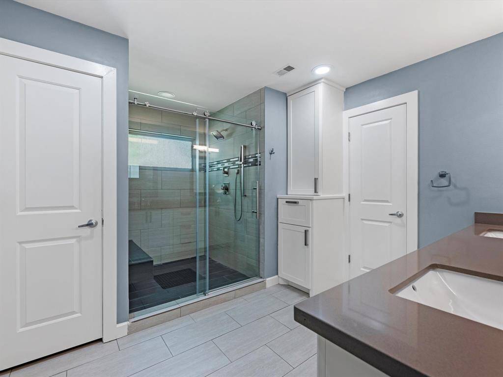 The primary bath has also been totally remodeled and brought up to modern standards! The walk in shower is a dream!