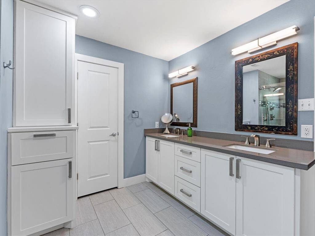 The recent vanity has double sinks and framed mirrors