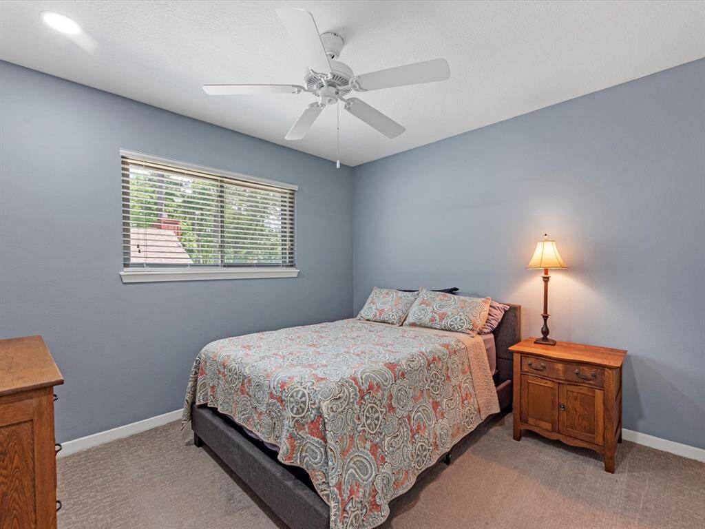 Anther secondary bedroom upstairs with ceiling fan