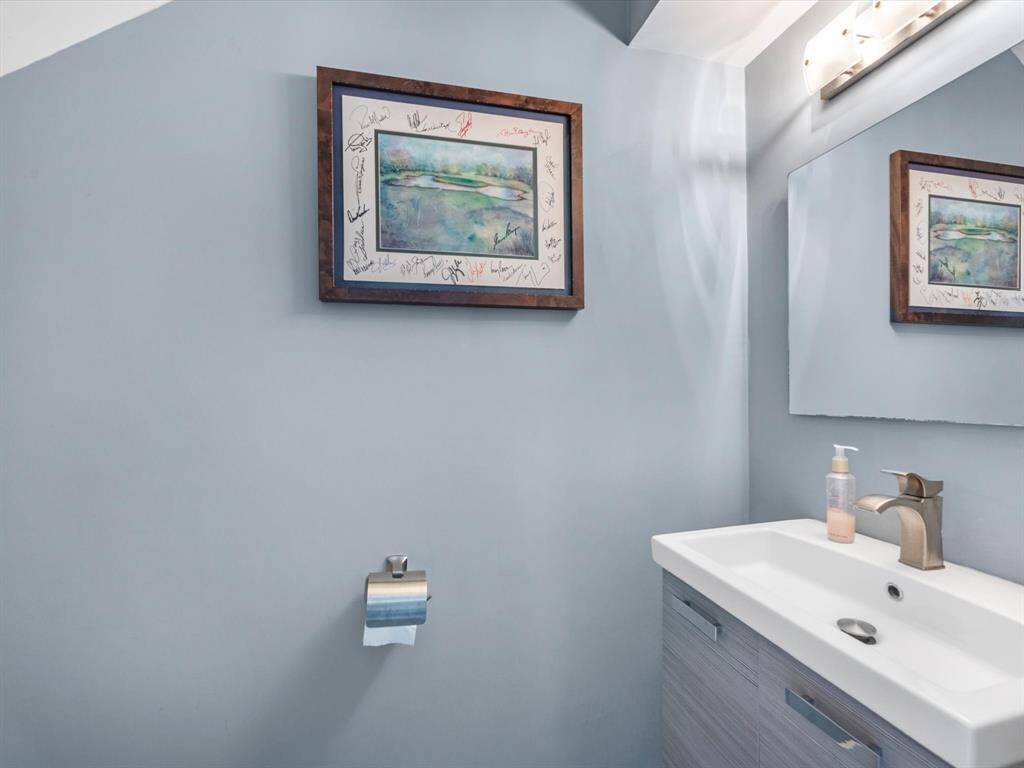 This powder room is tucked away just under the staircase