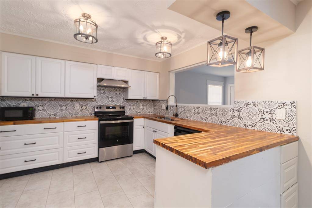 Spacious kitchen with butcher block countertops