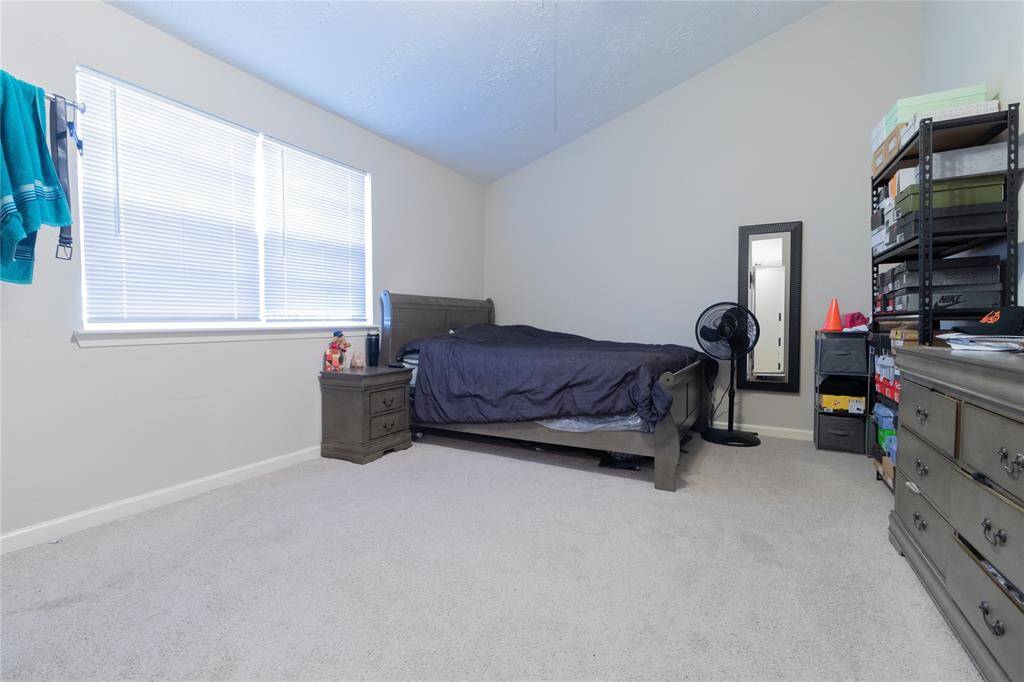 Spacious downstairs flex room currently being used as a 4th bedroom.