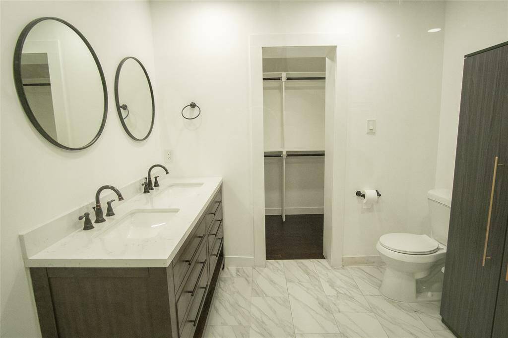 Primary bathroom with a walk in closet