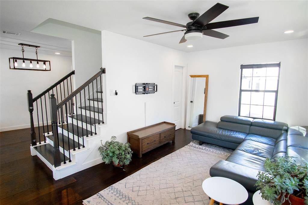 Stairs divide the living room and dining room